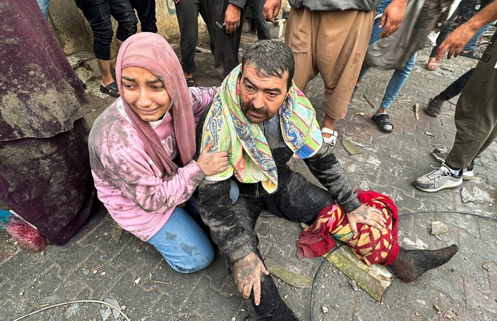 People react following an Israeli air strike on Palestinian houses, in Rafah in the southern Gaza Strip, on Tuesday. REUTERS