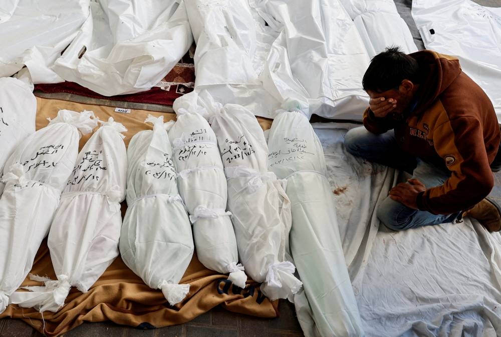 A mourner reacts next to the bodies of Palestinians killed in Israeli strikes, at Abu Yossef Al-Najar hospital, in Rafah in the southern Gaza Strip, on Tuesday. REUTERS