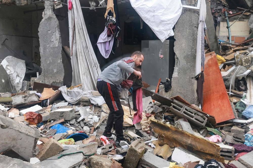 A Palestinian man inspects the damages amid the rubble following Israeli bombardment in Rafah in the southern Gaza Strip, on Wednesday. AFP 