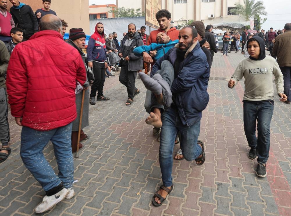 A wounded Palestinian man is rushed to Nasser hospital following Israeli strikes, in Khan Younis in the southern Gaza Strip, on Thursday. REUTERS