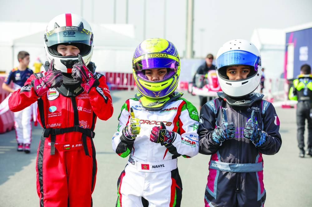    Young drivers strike a pose.