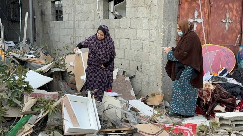 Palestinians inspect the site of an Israeli strike on a house in Khan Younis, in the southern Gaza Strip, on Saturday. REUTERS