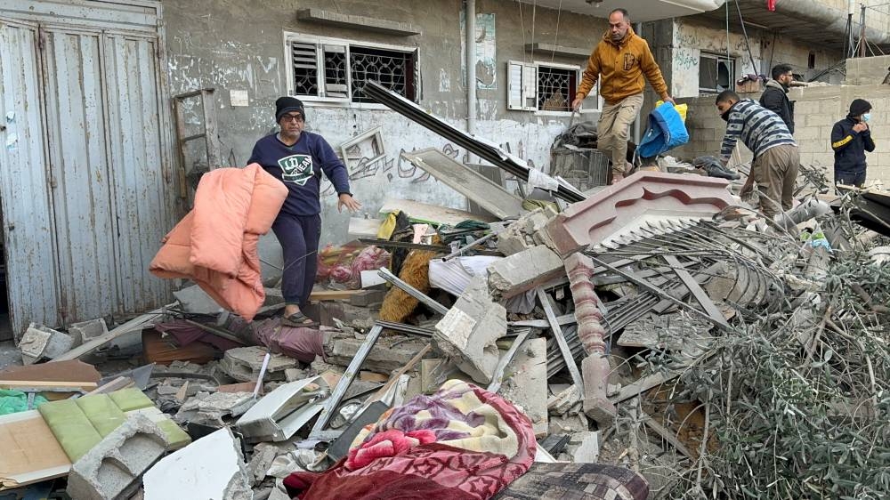 Palestinians inspect the site of an Israeli strike on a house in Khan Younis, in the southern Gaza Strip, on Saturday. REUTERS