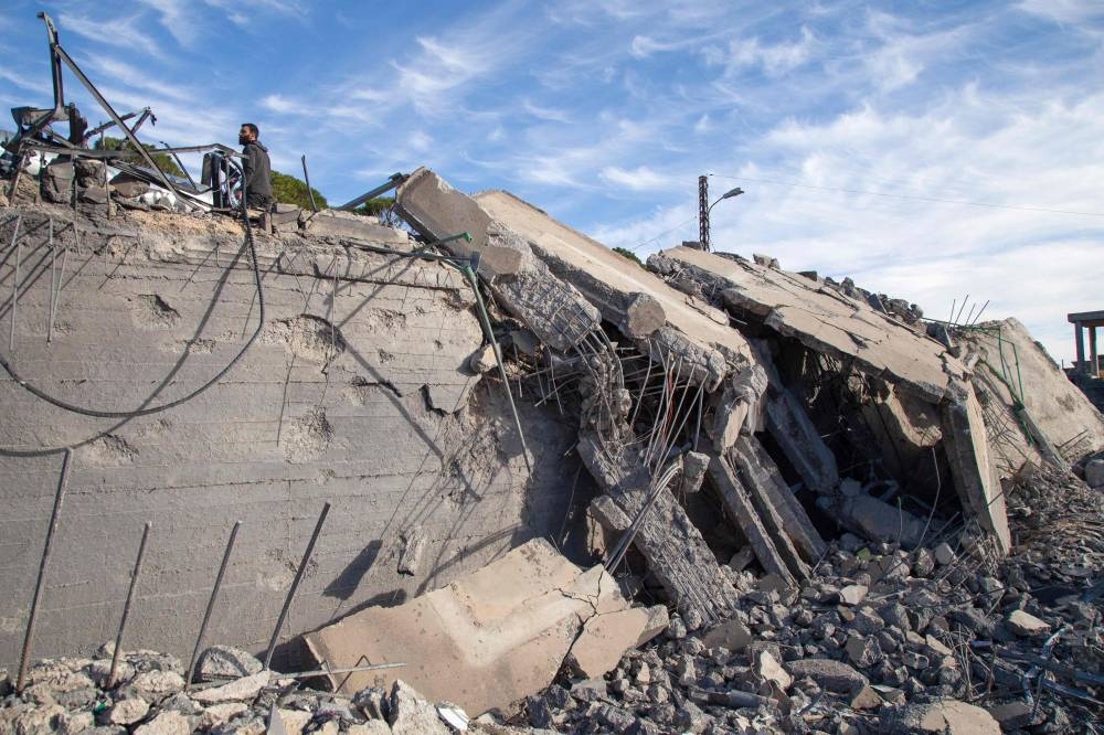 A man inspects the rubble of a house destroyed in reported Israeli bombardment on December 13 in the southern Lebanese village of Kfar Kila, on Saturday. AFP