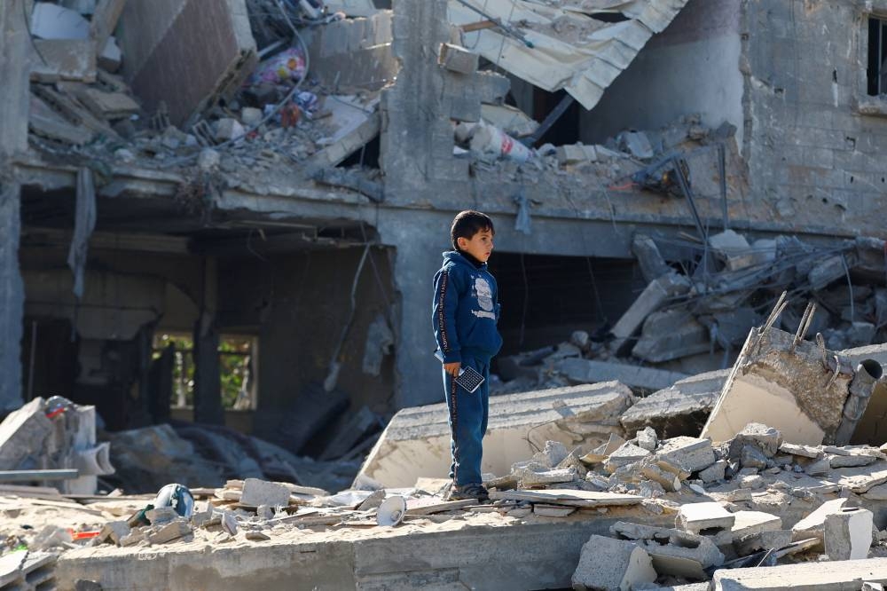 A Palestinian child looks on at the site of an Israeli strike on a house, in Rafah, in the southern Gaza Strip, on Saturday. REUTERS