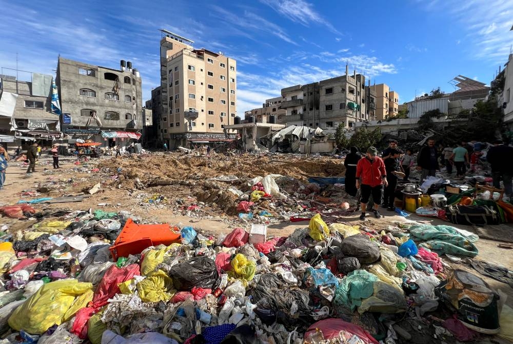 Palestinians inspect damages following an Israeli raid at Kamal Adwan hospital, in the northern Gaza Strip, on Saturday. REUTERS