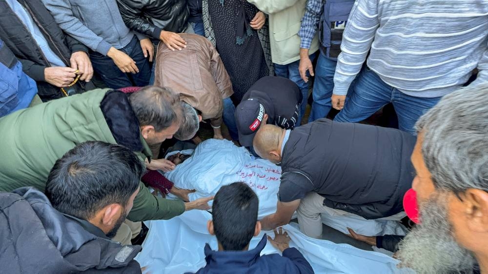 Mourners attend the funeral of Al Jazeera cameraman Samer Abu Daqqa, who was killed by an Israeli drone strike on Friday while reporting on the earlier bombing of a school sheltering displaced people, in Khan Younis in the southern Gaza Strip, on Saturday. REUTERS