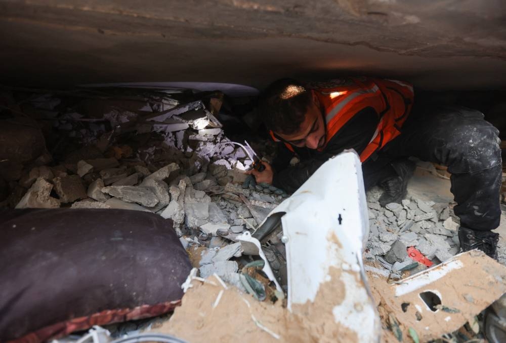 A Palestinian inspects the site of an Israeli strike on a house in Rafah in the southern Gaza Strip, on Sunday. REUTERS