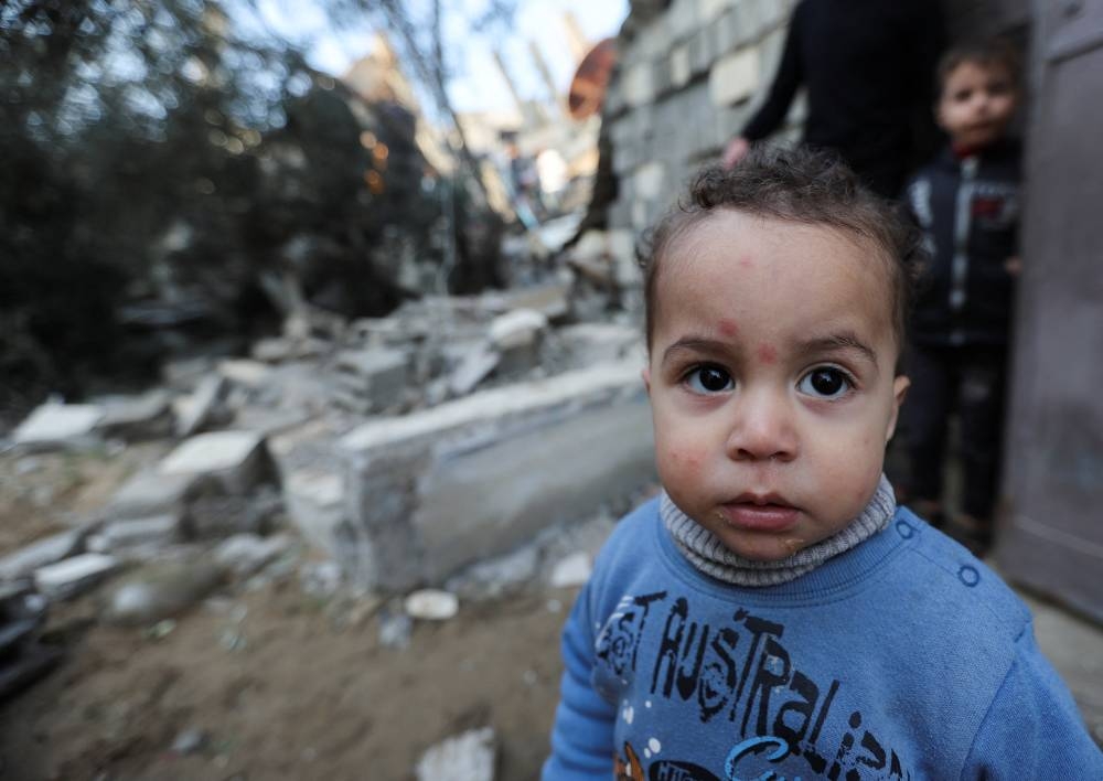 A Palestinian child looks on at the site of an Israeli strike on a house in Rafah in the southern Gaza Strip, on Sunday. REUTERS