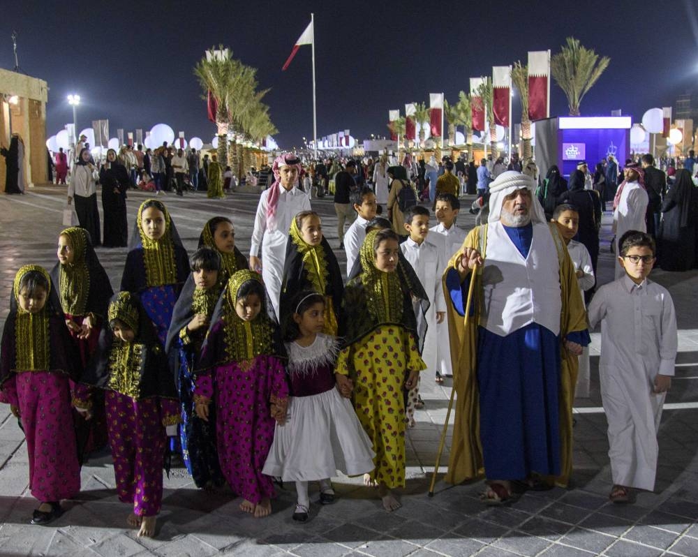 The traditional Qatari storyteller and children following him; another activity from Darb Al Saai. PICTURE: Noushad Thekkayil