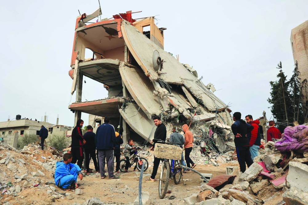 Palestinians check the rubble following Israeli bombardment in Khan Yunis in the southern Gaza Strip. (AFP)