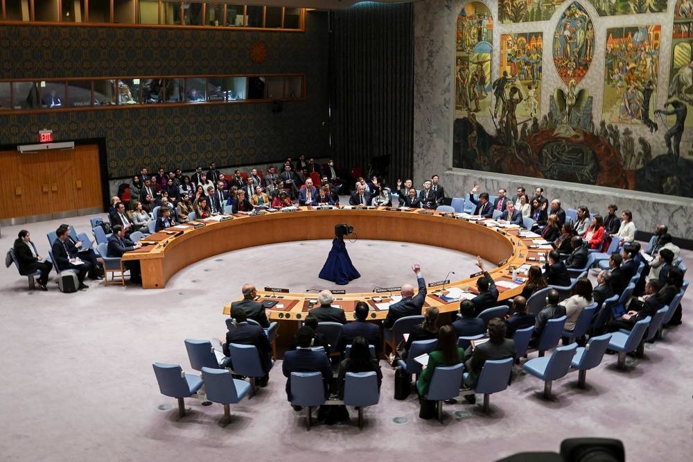 Members of the United Nations Security Council vote on a proposal to demand that Israel and Hamas allow aid access to the Gaza Strip - via land, sea and air routes - and set up UN monitoring of the humanitarian assistance delivered, during a meeting at the UN headquarters in New York, on Friday.  REUTERS

