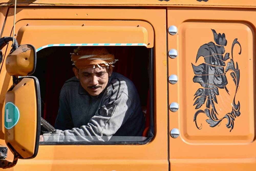 A driver steers his truck carrying humanitarian aid upon arriving from Egypt on the Israeli side of the Kerem Shalom border crossing with the southern Gaza Strip on Friday. AFP