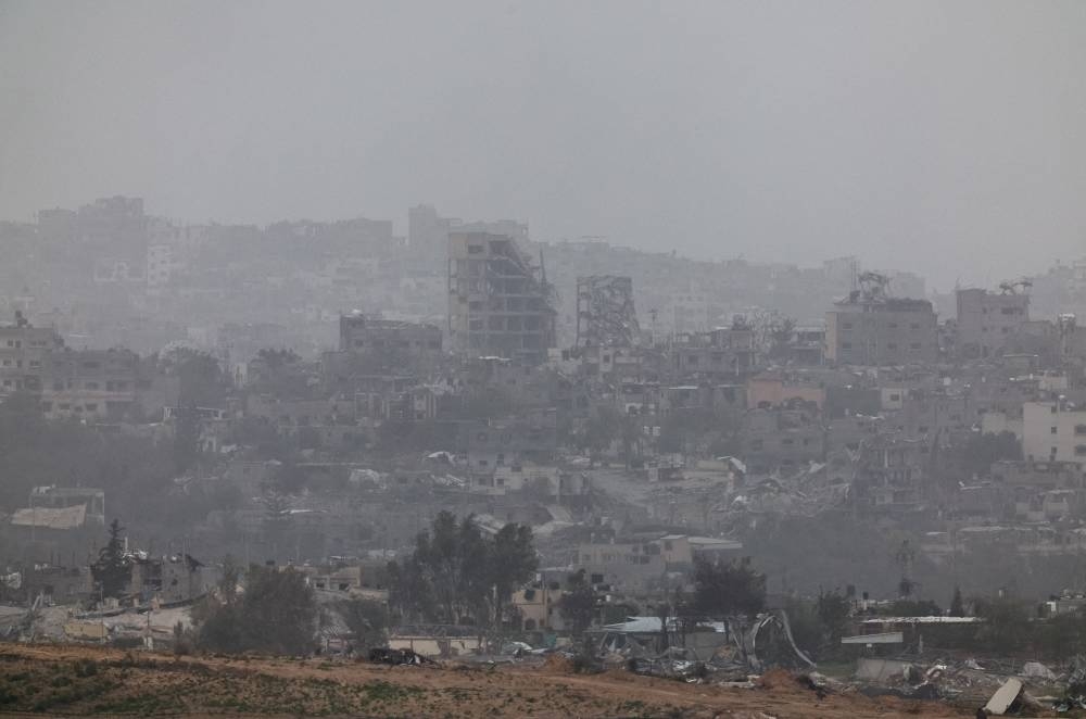 Buildings lie in ruin in Gaza, as seen from southern Israel, on Saturday. REUTERS