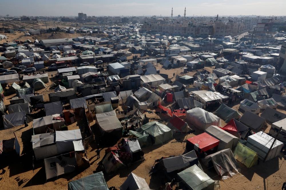 Displaced Palestinians, who fled their houses due to Israeli strikes, shelter in a tent camp, in Rafah in the southern Gaza Strip, on Sunday. REUTERS