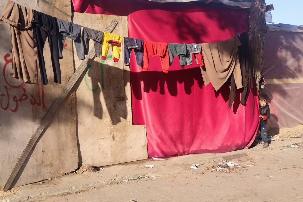 A displaced Palestinian boy, who fled his house due to Israeli strikes, shelters in a tent camp, in Rafah in the southern Gaza Strip, on Sunday. REUTERS