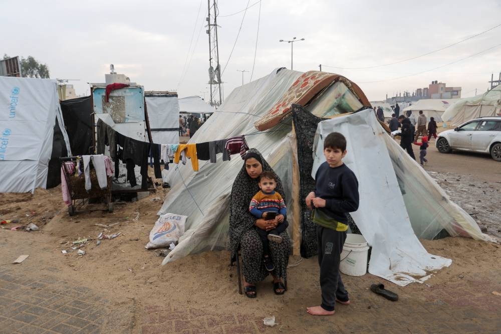 Displaced Palestinians, who fled their houses due to Israeli strikes, shelter in a tent camp, in Rafah in the southern Gaza Strip, on Monday. REUTERS