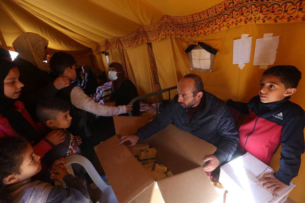 Displaced Palestinians receive medications in a medical tent set up by volunteers, in Rafah in the southern Gaza Strip, on Monday. REUTERS