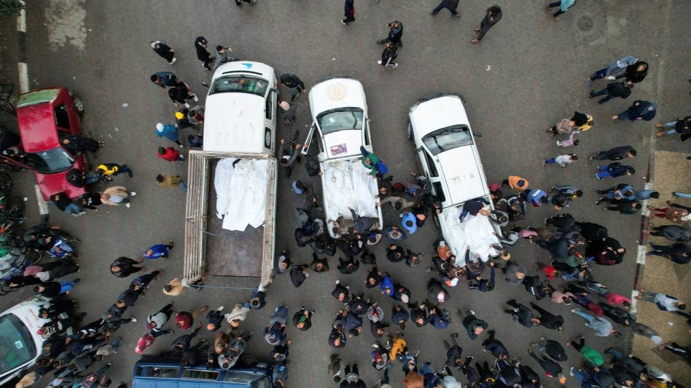 Mourners gather next to the bodies of Palestinians killed in Israeli strikes, at a hospital in the central Gaza Strip, on Monday. REUTERS