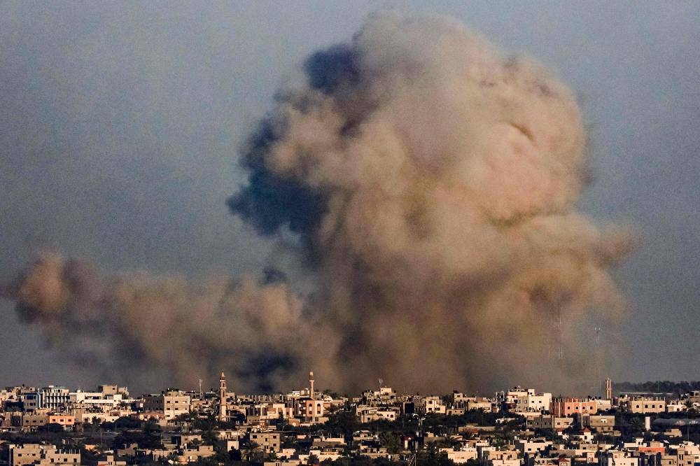A smoke plume erupts over Khan Yunis from Rafah in the southern Gaza strip during Israeli bombardment, on Tuesday. AFP