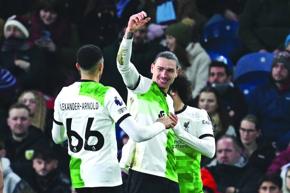 Liverpool striker Darwin Nunez celebrates with teammates after scoring the opening goal of the Premier League match against Burnley at Turf Moor in Burnley on Tuesday. (AFP)