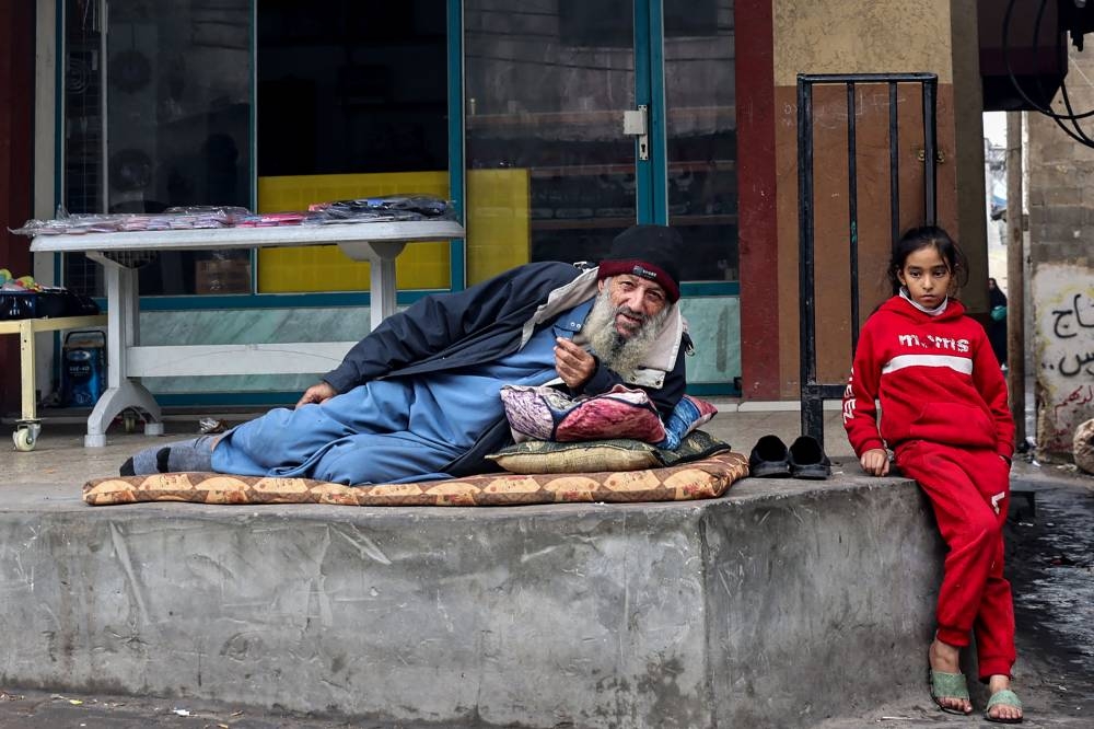 A displaced Palestinian man and a child are pictured in Rafah in the southern Gaza Strip, on Wednesday. AFP