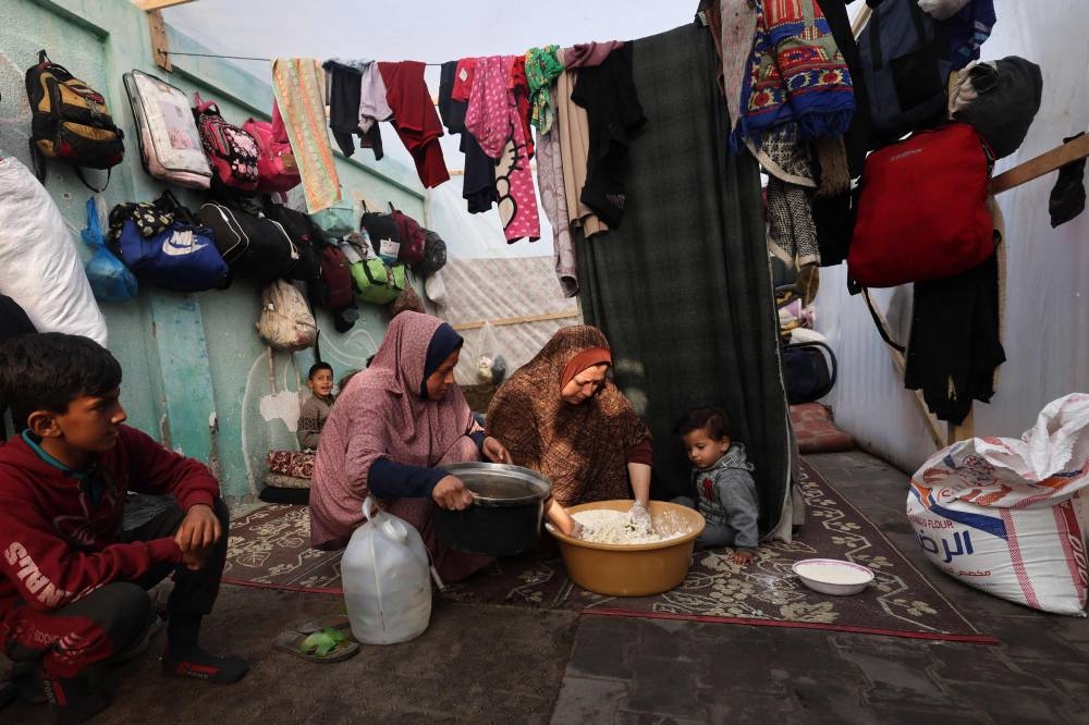 Displaced Palestinians go on with their lives inside a tent in Rafah in the southern Gaza Strip, on Wednesday. AFP