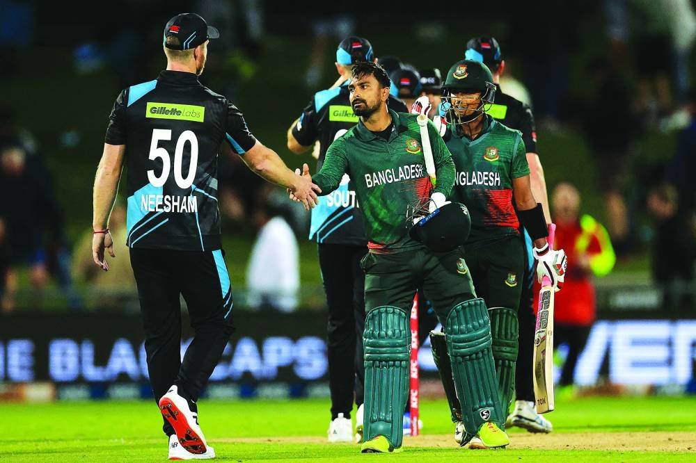 Bangladesh’s Litton Das shakes hands with New Zealand’s James Neesham after Bangladesh’s victory in the first Twenty20I at McLean Park in Napier on Wednesday. (AFP)