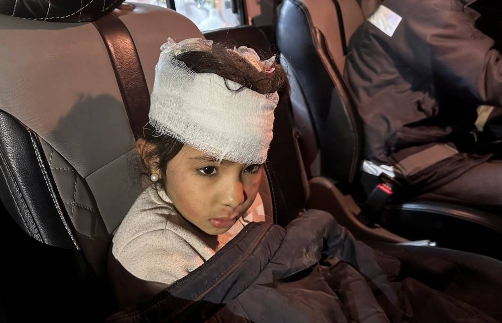 A Palestinian girl, wounded in an Israeli strike on a house, sits in an ambulance, in Rafah in the southern Gaza Strip, on Friday. REUTERS