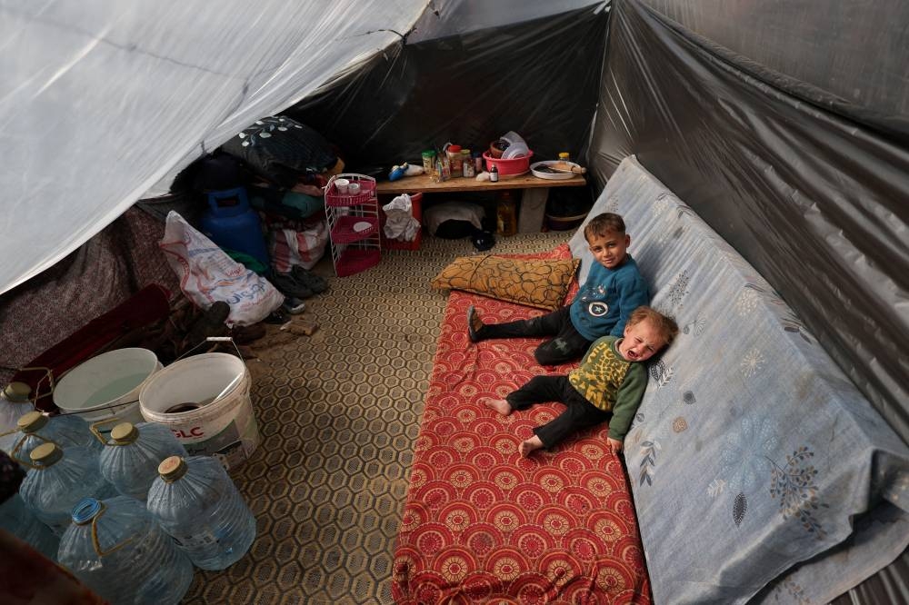 Displaced Palestinian children, who fled their homes due to Israeli strikes, shelter in a tent camp, in Rafah, southern Gaza Strip, on Friday. REUTERS