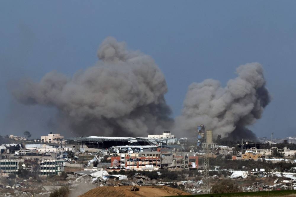 A picture taken from a position in southern Israel, along the border with the Gaza Strip, shows smoke billowing over the Palestinian territory during Israeli bombardment, on Friday. AFP