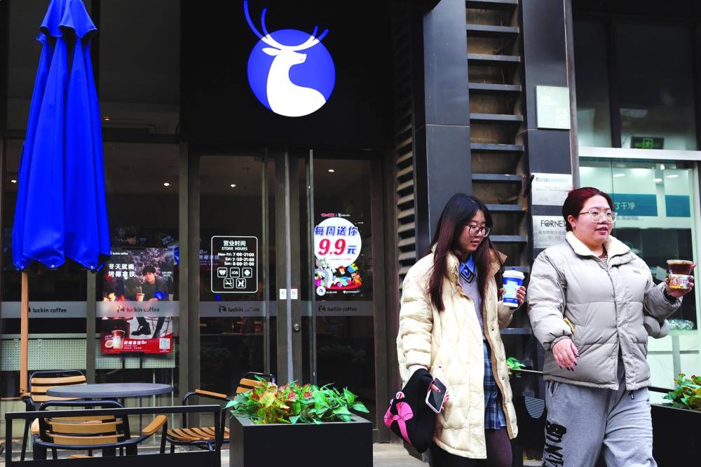 
Women leave a Luckin Coffee store in Beijing. (Reuters) 