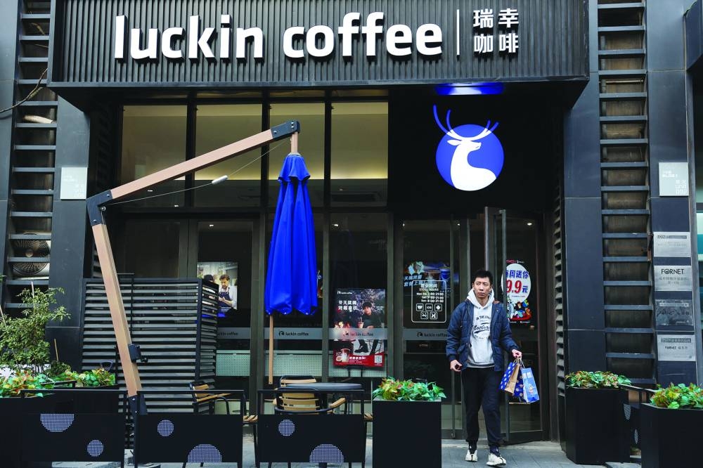 
A man leaves a Luckin Coffee store in Beijing.  (Reuters) 