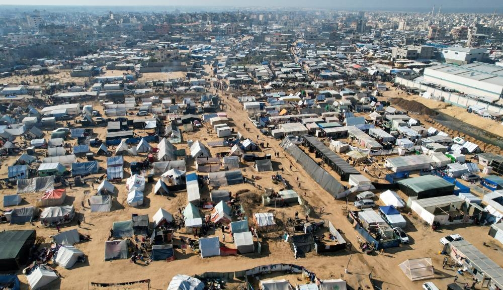 Displaced Palestinians, who fled their homes due to Israeli strikes, shelter in a tent camp, on Friday. REUTERS