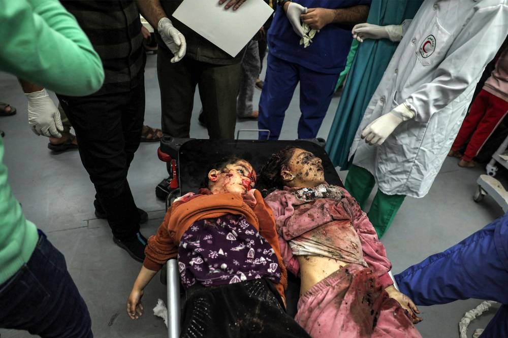 The bodies of the two girls killed by Israeli bombardment arrive at the European Hospital in Khan Yunis in the southern Gaza Strip, on Sunday. AFP