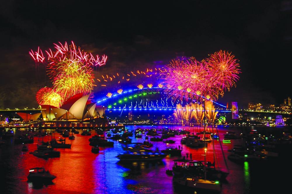Fireworks explode over the Sydney Harbour Bridge and Sydney Opera House (L) during New Year's Eve celebrations in Sydney.