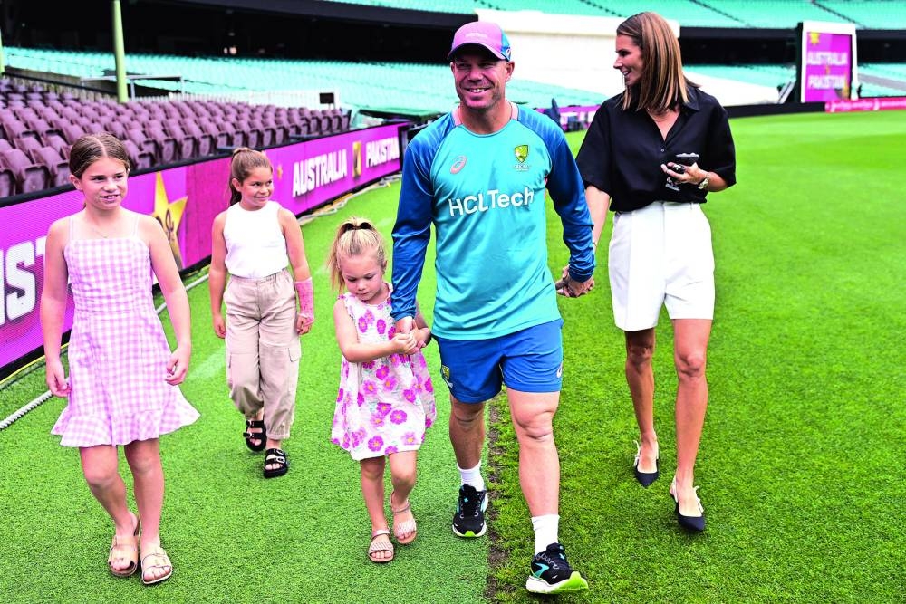 David Warner, his wife Candice and their children leave after a press conference at the Sydney Cricket Ground in Sydney on Monday. (AFP)