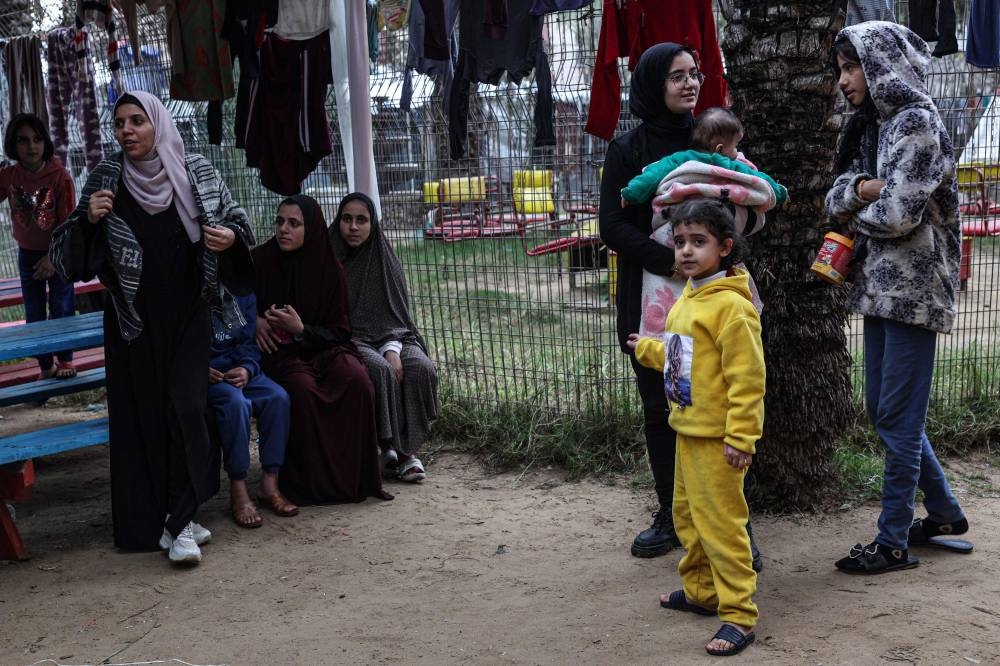 Displaced Palestinians are pictured at the zoo in Rafah in the southern Gaza Strip on Tuesday. AFP