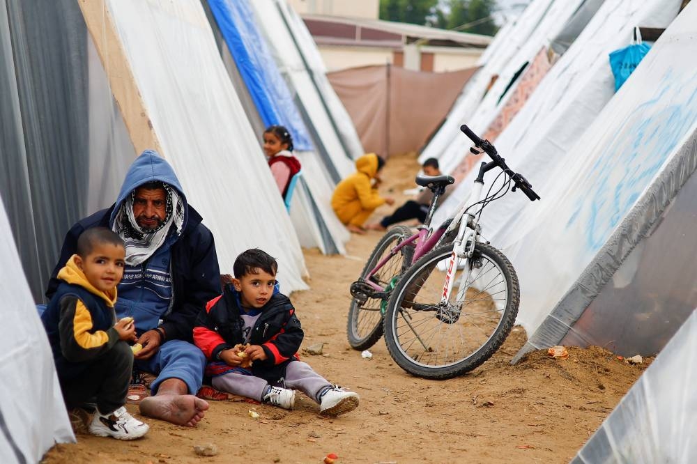 Displaced Palestinians, who fled their homes due to Israeli strikes, shelter at a tent camp in Rafah, southern Gaza Strip on Tuesday. REUTERS