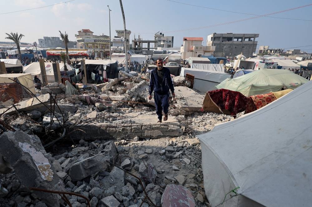 Palestinian man Hamada Abu Sleyma, whose wife, all his 6 children and two grandchildren were killed in an Israeli strike that destroyed his house, walks on rubble, in Rafah in the southern Gaza Strip on Monday. REUTERS