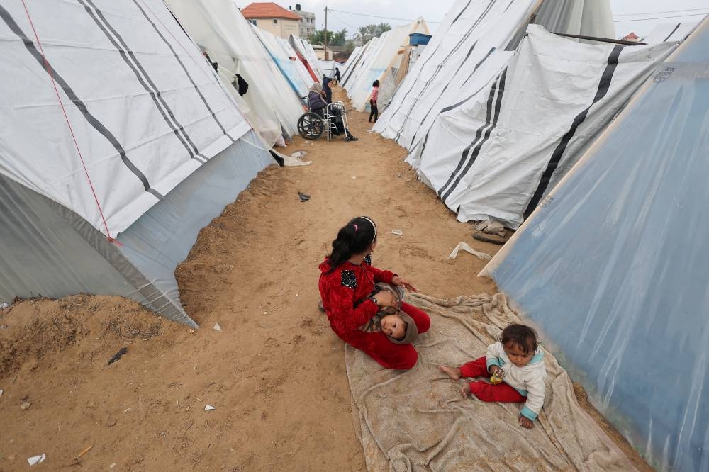 Displaced Palestinians, who fled their homes due to Israeli strikes, shelter at a tent camp in Rafah, southern Gaza Strip on Tuesday. REUTERS