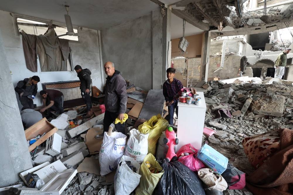 Palestinians inspect a house damaged in an Israeli strike in Rafah in the southern Gaza Strip, on Wednesday. REUTERS