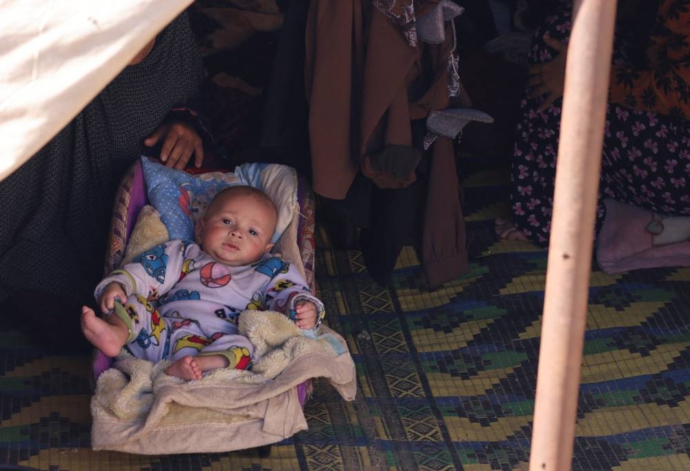 Displaced Palestinians, who fled their homes due to Israeli strikes, shelter in a tent camp, in Rafah, southern Gaza Strip, on Wednesday. REUTERS
