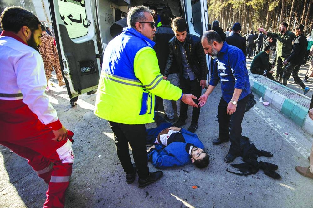 Iranian emergency services arrive at the site where two explosions in quick succession struck a crowd marking the anniversary of the 2020 killing of Guards general Qasem Soleimani, near the Saheb al-Zaman Mosque in the southern Iranian city of Kerman on Wednesday. AFP