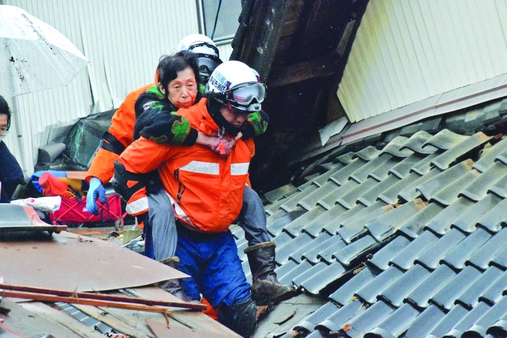 
A resident is carried out after being rescued by firefighters in the city of Suzu, Ishikawa prefecture. 