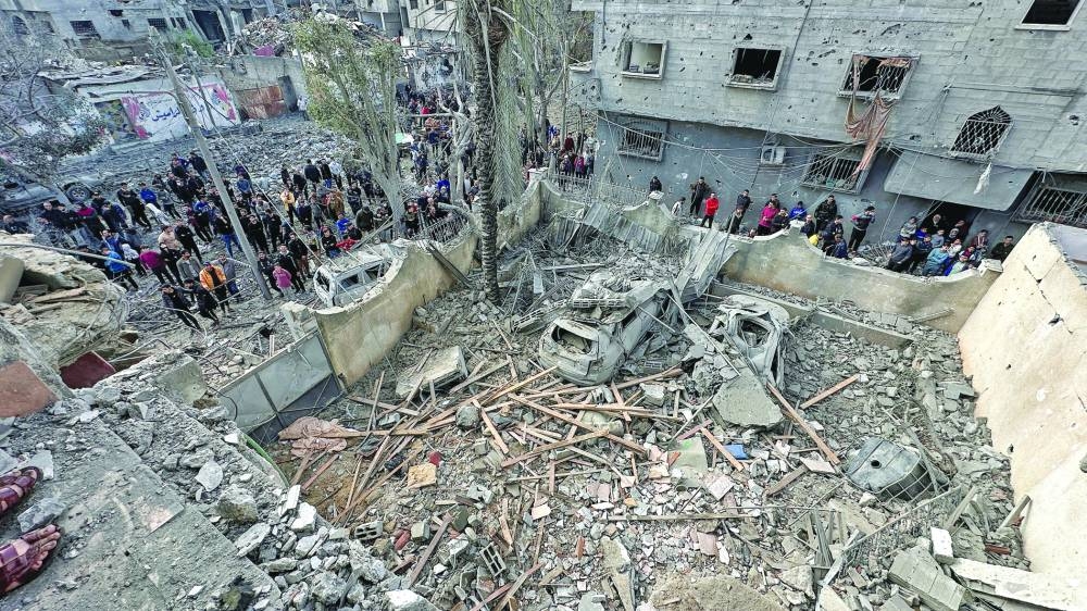 Palestinians inspect the site of an Israeli strike on a house, in Jabalia in the northern Gaza Strip, Wednesday.
