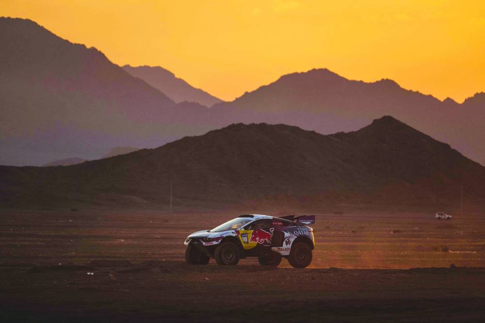 
Qatari driver Nasser al-Attiyah and his French co-driver Mathieu Baumel en route to their base camp in Al-Ula, Saudi Arabia. (AFP) 