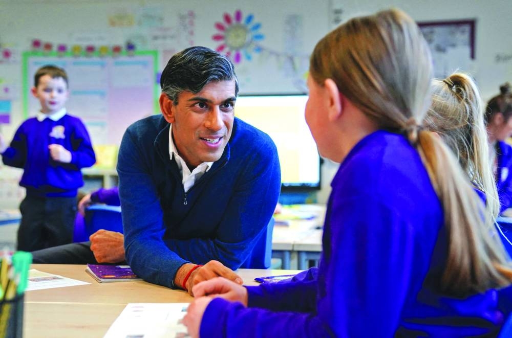
Prime Minister Rishi Sunak with schoolchildren during a visit to Woodland View Primary School in Sutton-in-Ashfield, central England. 