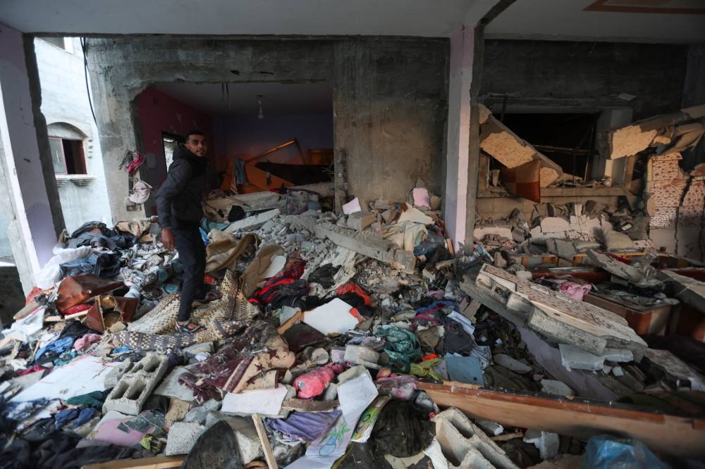 A Palestinian man inspects a house damaged in an Israeli strike,  on Friday. REUTERS