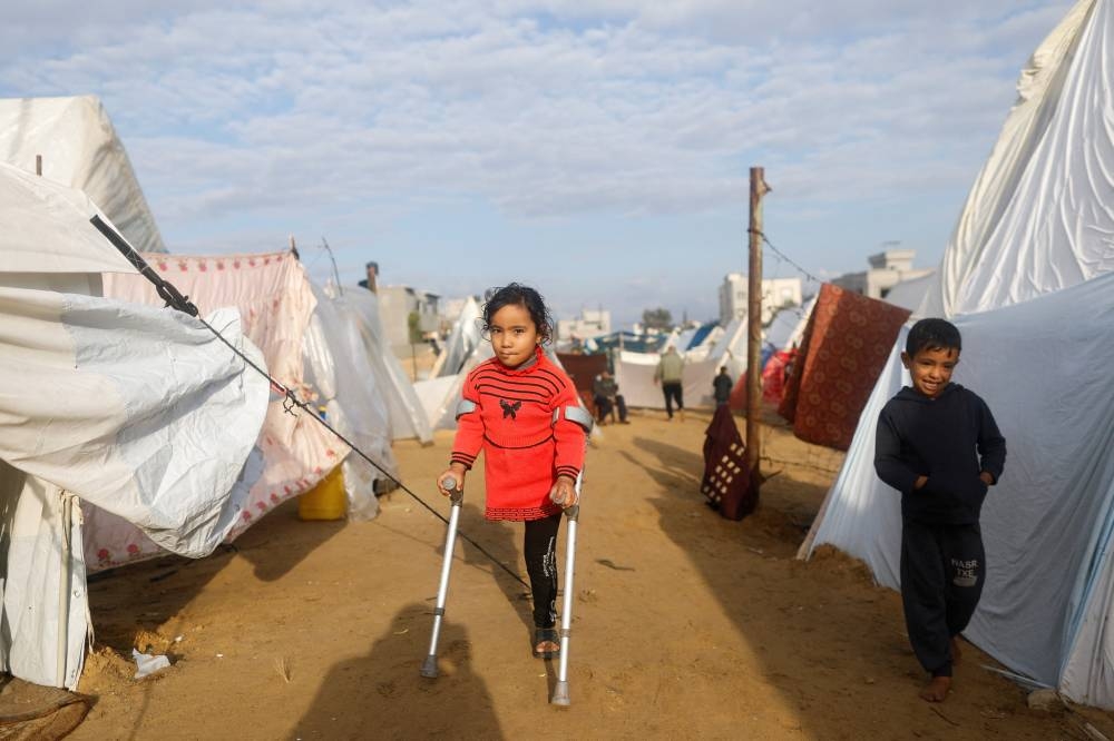 Displaced Palestinian kids, who fled their homes due to Israeli strikes, shelter in a tent camp in Rafah, southern Gaza Strip, on Friday. REUTERS